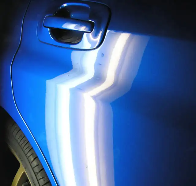 Vehicle door dent repair before and after PDR treatment