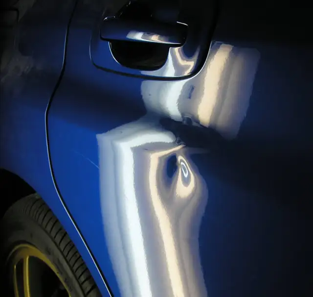 Vehicle door dent repair before and after PDR treatment
